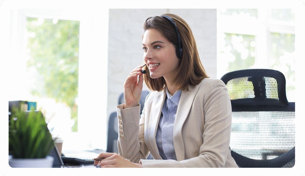 A friendly customer support representative wearing a headset and smiling